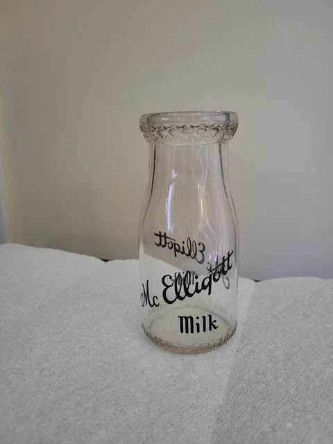 Mc Elligott Milk 1/2 pint clear glass milk bottle.