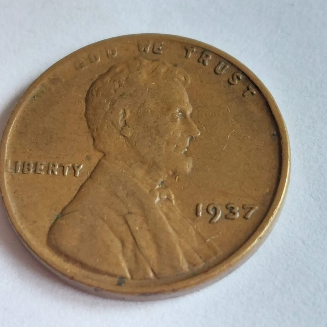 1937 wheat penny  L  in edge of rim