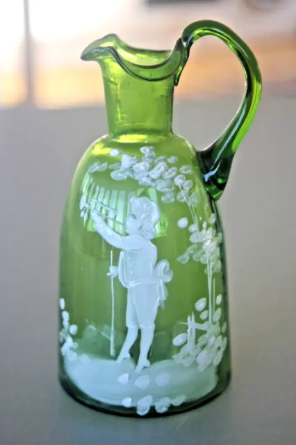Antique bohemian green glass 'Mary Gregory' style jug boy with trumpet