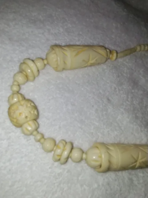 looks like Artigue ancient carved cream color beaded necklace.