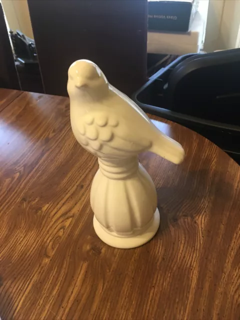 White Ceramic Bird Sitting On Pedestal