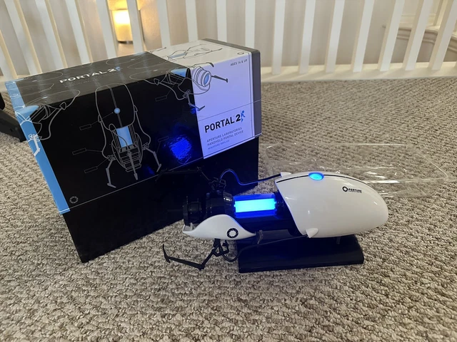 ThinkGeek Portal 2 Handheld Aperture MiniPortal Gun Miniature Replica  & Stand