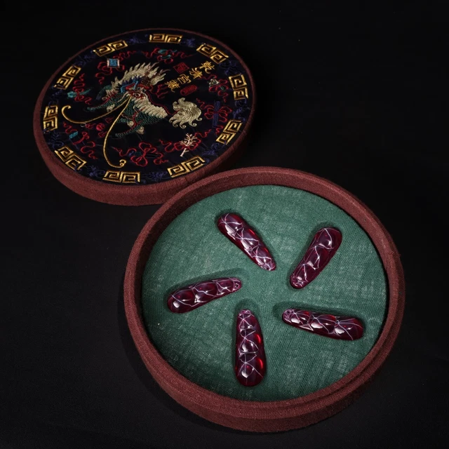 A box of precious handmade carved gemstone pendants