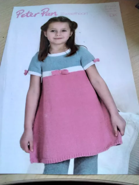 Peter Pan Knitting Pattern P1149. Child's dress with bows. DK. 18-26 inch chest