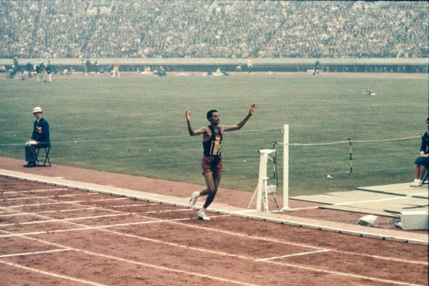ABEBE BIKILA OF Ethiopia Crosses The Finishing Tape As Top In T 1964 ...