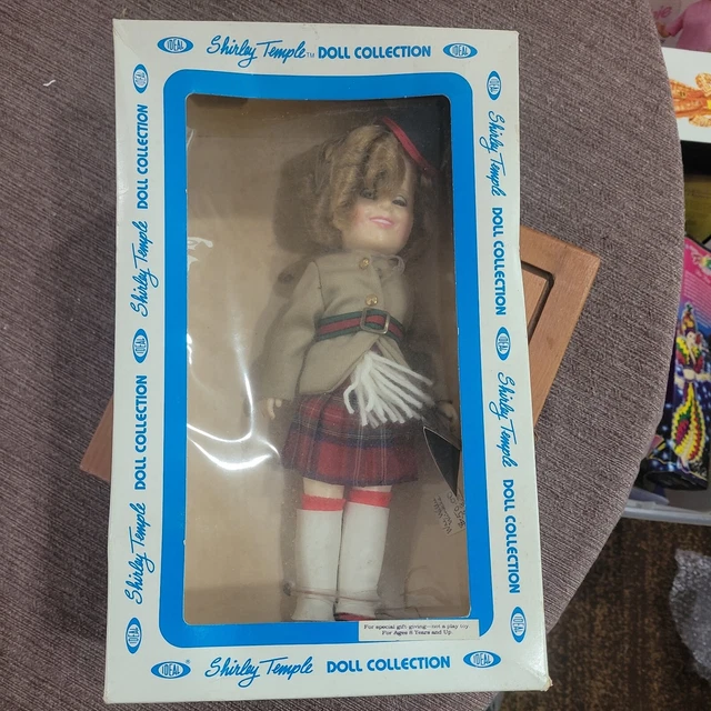 vintage Shirley Temple doll with plaid pleated skirt and Scottish attire 