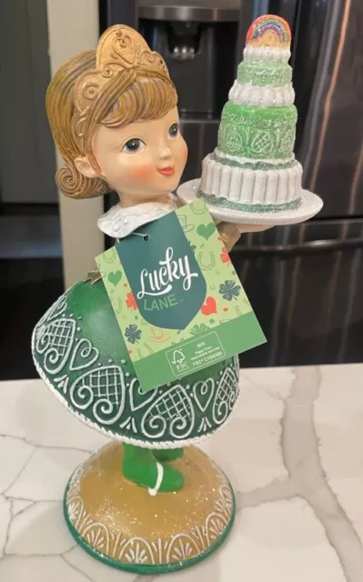 St Patrick’s Day Gingerbread  Girl Holding A Rainbow Cake by Lucky Lane