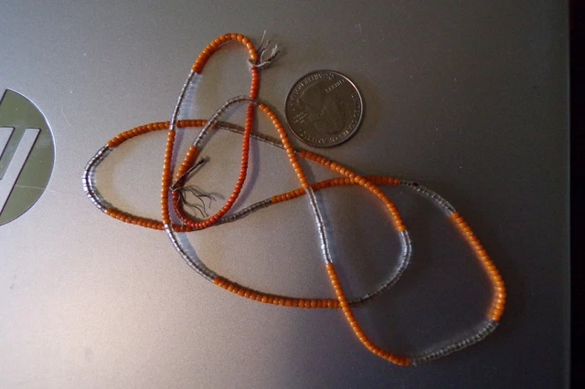 Strand Of Pumpkin Orange Seed Beads And Clear Beads.