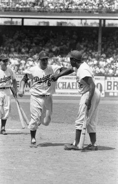 Brooklyn Dodgers Jackie Robinson and Carl Furillo shake hands vs S - Old Photo