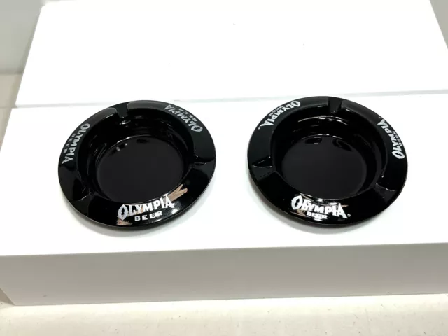 2-Vintage Olympia Beer Ashtrays. Black Glass. White Lettering. 4 1/4” Across.