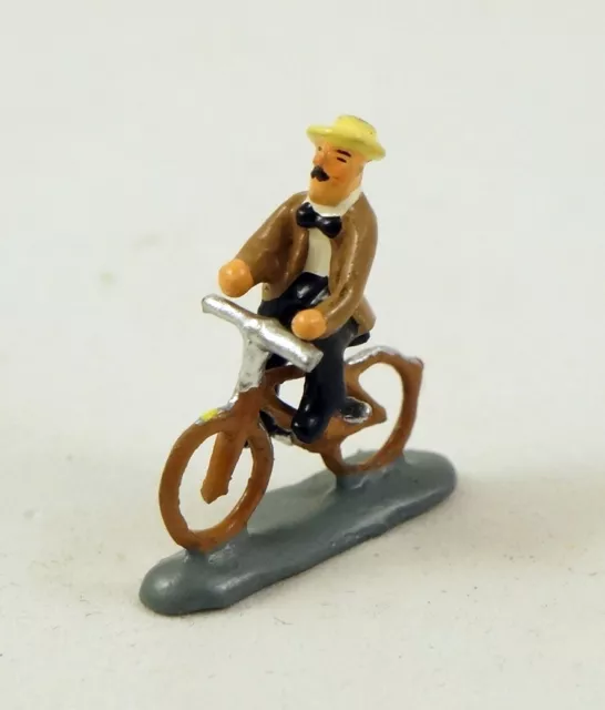 J Carlton by Gault French Miniature Figurine Man in Hat Riding Bicycle in Paris
