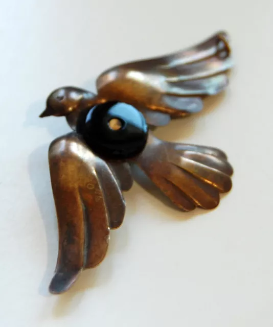 VINTAGE RAW BRASS BIRD SPARROW IN FLIGHT METAL STAMPING PENDANT w/ BLACK GLASS