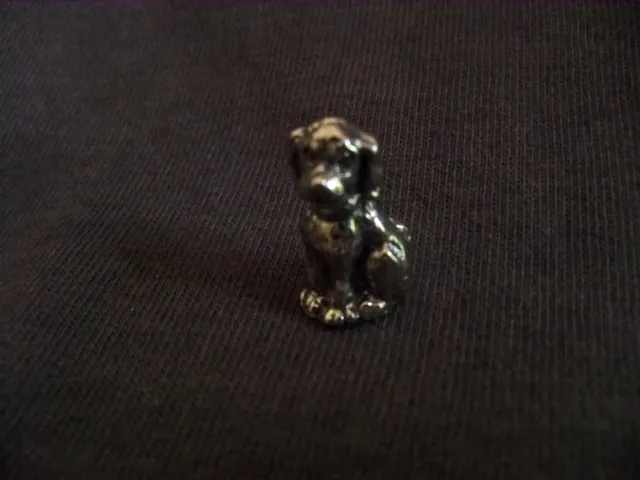 Tiny Metal Dog Figurine sitting , came from auction, may be hard to find item