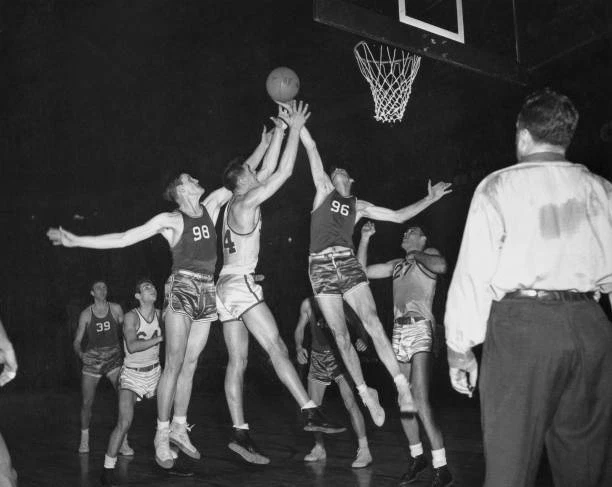 Basketball players jumping for ball during a match US 1945 Old Photo