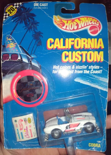 Hot Wheels CALIFORNIA CUSTOM 1990 Shelby COBRA 1:64Scale White w Decal/C.C. Coin