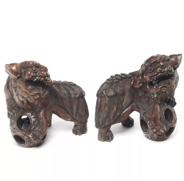 A pair of Chinese carved wooden Foo dogs 6 1/2”