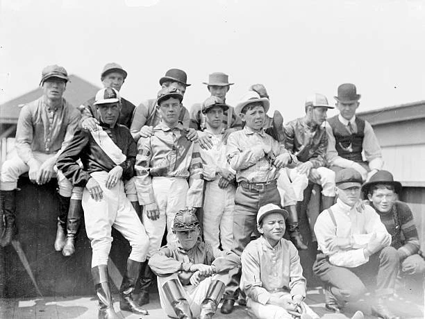 GROUP OF FIFTEEN Jockeys Wearing Racing Silks And Caps Gathering Old group-of-fifteen-jockeys-wearing-racing-silks-and-caps-gathering-old