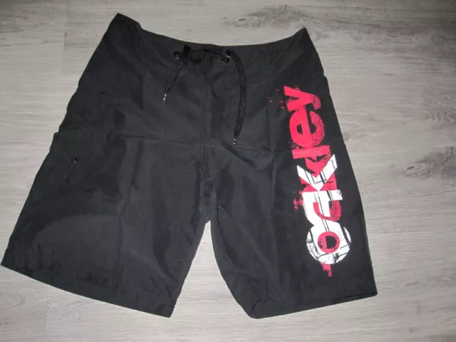 Oakley black shorts 34 board Shorts (with red /white big "oakley" on side) Oakley black shorts 34 board Shorts (with red /white big "oakley" on side)