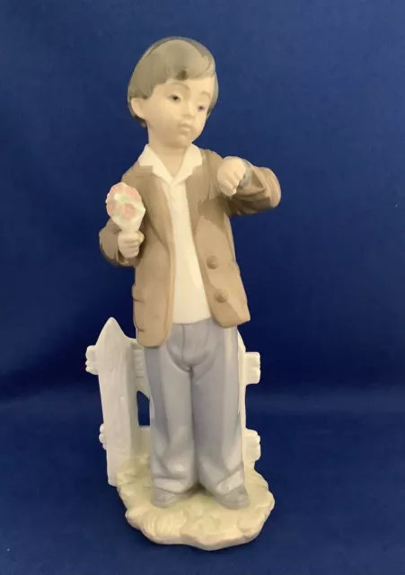 Nao by Lladro Porcelain Figurine She's Late Boy by Gate Holding Flowers