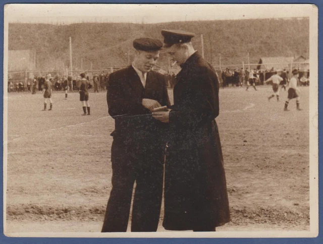Guys smoke cigarettes near a football match Vintage Photo