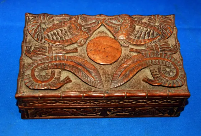 An antique or vintage Oriental heavily carved wooden box with dragon details