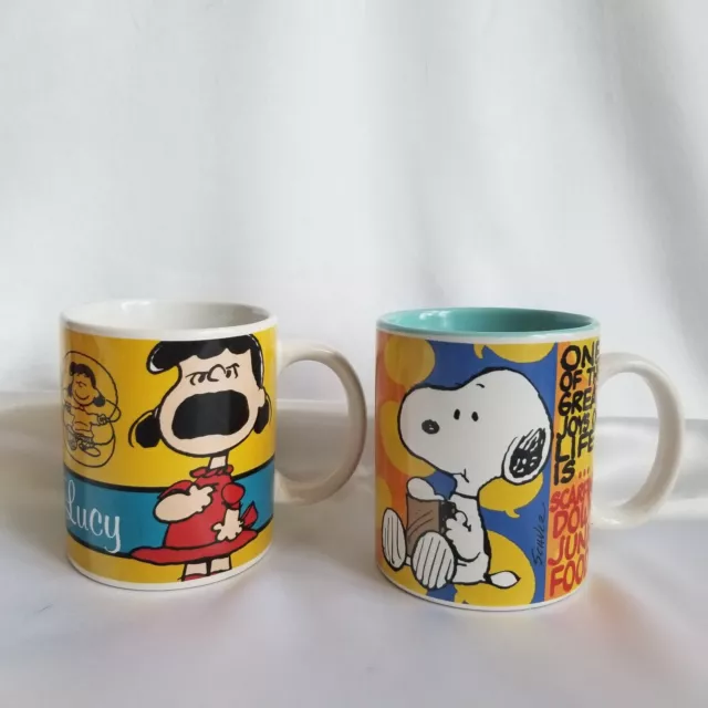 2 Peanuts Coffee Mugs Snoopy Scarfing Down Junk Food Lucy 60 years celebrate