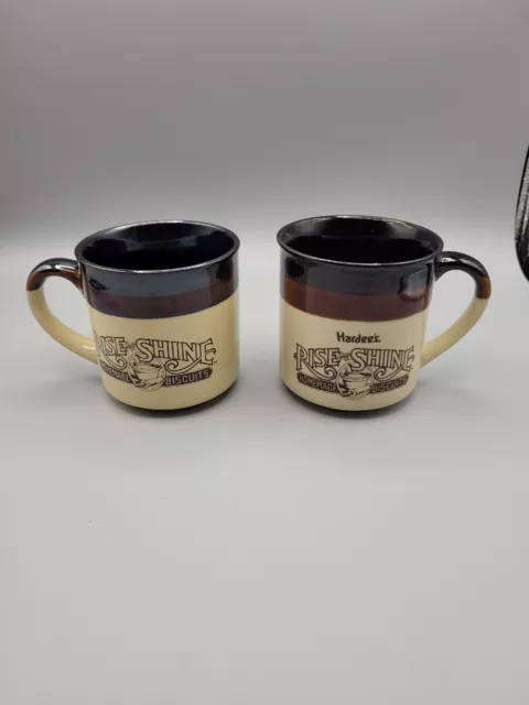 2 Vintage Hardees Rise And Shine Homemade Biscuits Coffee Cup Mugs 86 and 89.