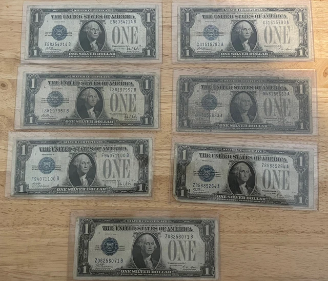 Seven 1928A & 1928B One Dollar Funny Back Silver Certificate Blue Seal W/Sleeve