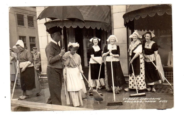 MI - HOLLAND MICHIGAN RPPC Postcard STREET SCRUBBING WOMEN BROOMS MAN UMBRELLA