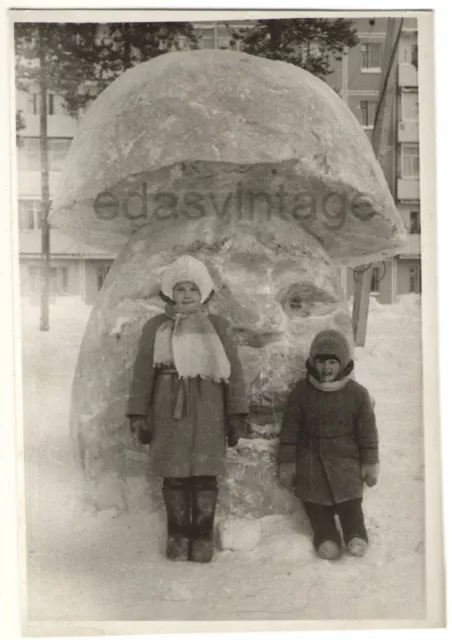 Interesting ice sculpture Mushroom Odd face Head Snowman Kids playground photo