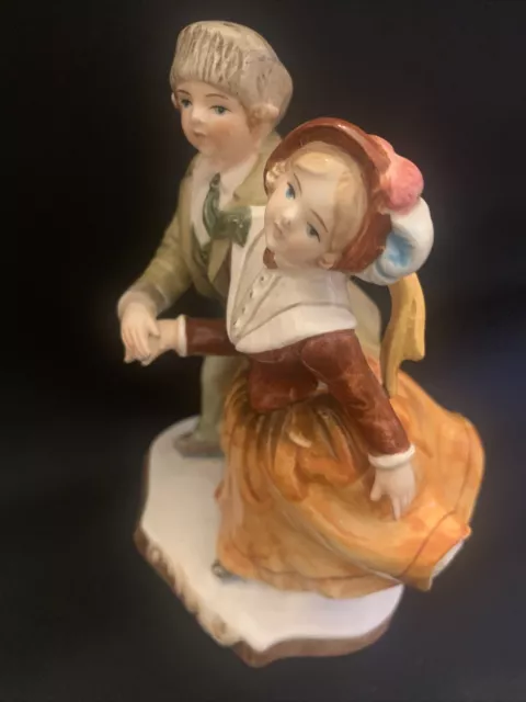 Porcelain figure of an ice skating couple, Schmid Company, Japan, antique style