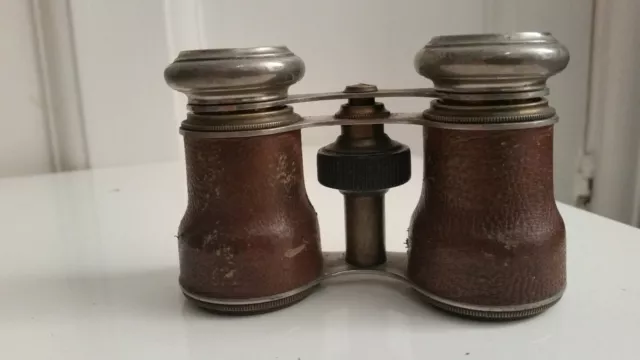 A pair of vintage binoculars stamped Touring Club London Paris, cased