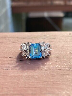925 Sterling Silver And Rhodium Plated Carnival Blue Topaz With CZ Accents. 7.
