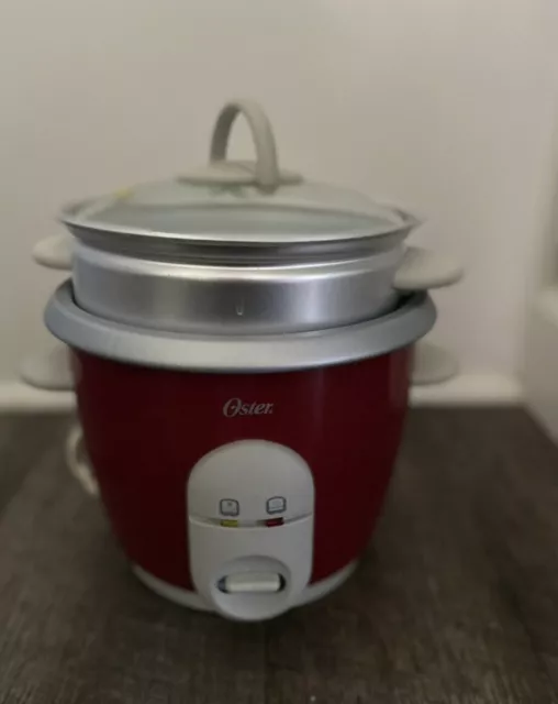 https://www.picclickimg.com/cs0AAOSwiUtkL1ON/Oster-6-Cup-Rice-Cooker-with-Steamer-RedPre-owned.webp