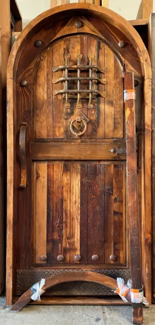 Rustic reclaimed lumber arched door solid wood storybook castle winery speakeasy
