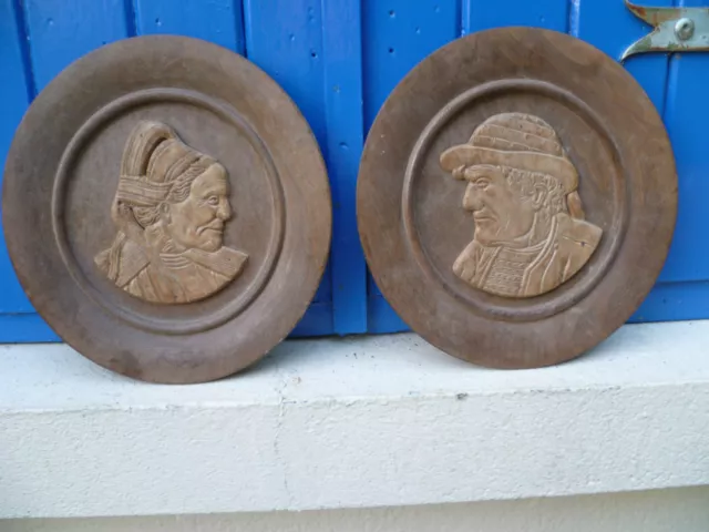 A Vintage Pair Of French, Carved Wooden Wall Plates, Of A Breton Lady & Man