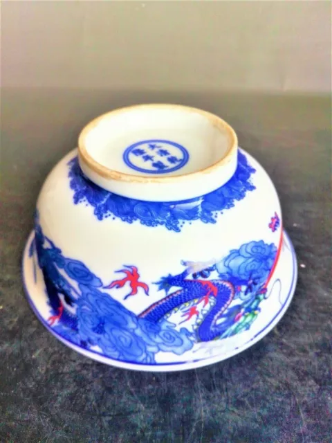 Chinese folk old porcelain bowl with blue and white glaze and red dragon pattern