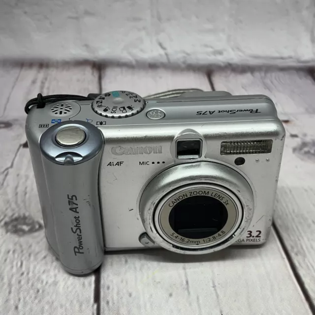 Canon PowerShot A75 3.2MP Digital Camera - Silver W/Strap Powers On. Works Read