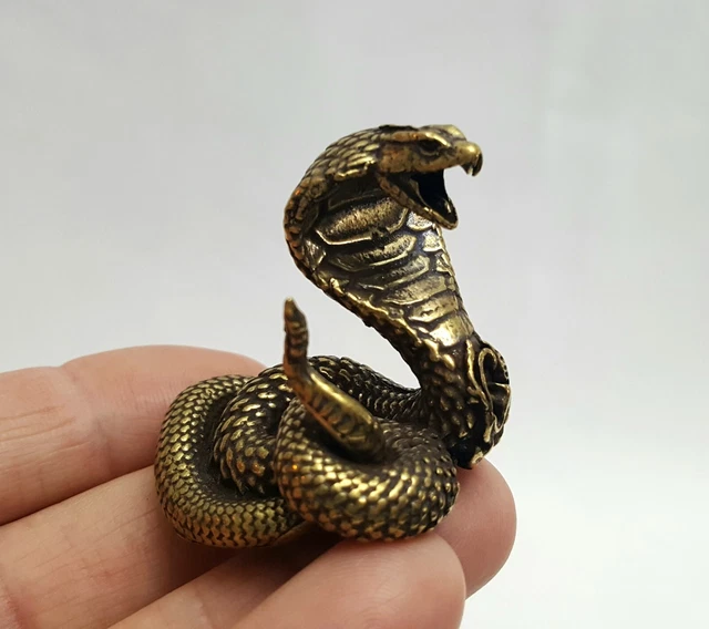 Vintage cast bronze figurine of a coiled cobra snake hood spread ready to strike