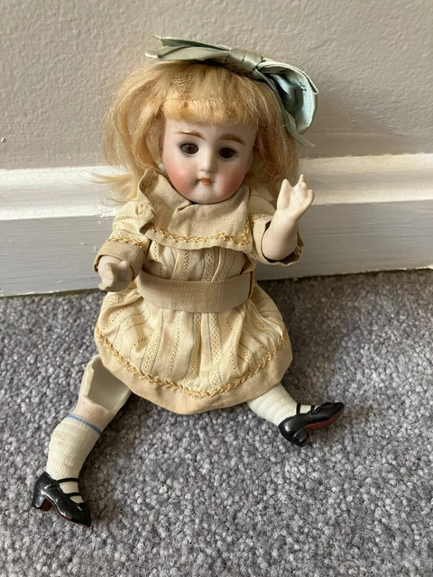 Antique  painted bisque doll 7" tall as is sleep eyes mohair wig marked '130' ?