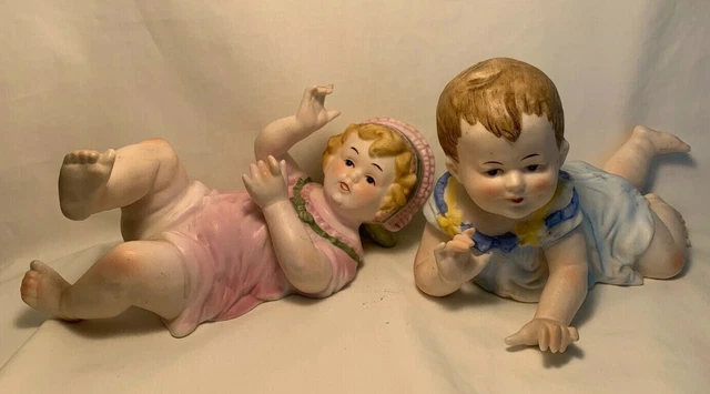 Pair 8.5" Mid Century Bisque Porcelain Pottery Piano Babies Boy & Girl Figurines