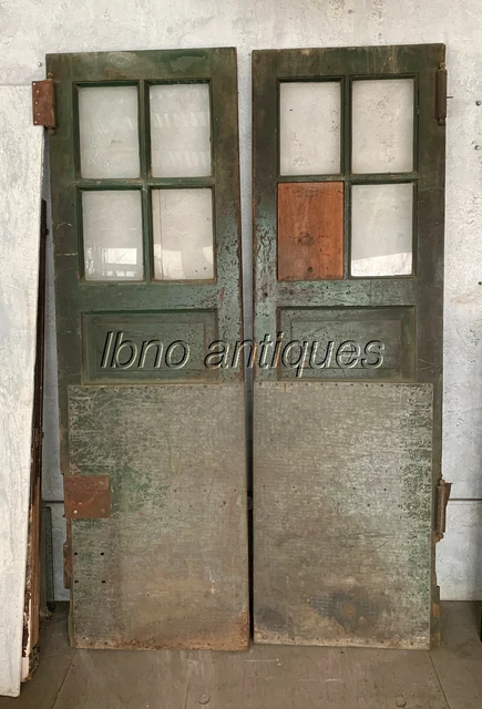 PAIR OF 1940s VINTAGE INDUSTRIAL WOODEN DOORS W/ GLASS PANES AND STEEL PLATES.