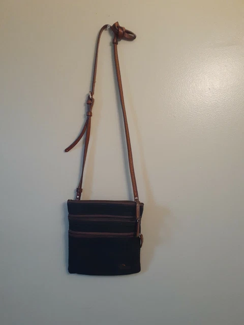 Used Dooney Bourke Nylon CROSSBODY Bag  Black with brown stap and pink Inside.