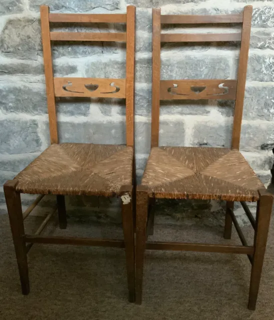 Antique Arts and Crafts Pair of Oak Chairs Rush Seats Pierced Heart Motif