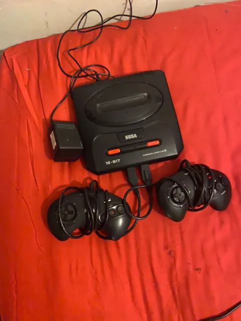 Sega Mega Drive II console and two controllers. Tested and Working
