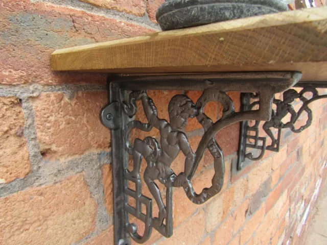 PAIR OF CHERUB ANTIQUE IRON cast iron rustic shelf support wall brackets