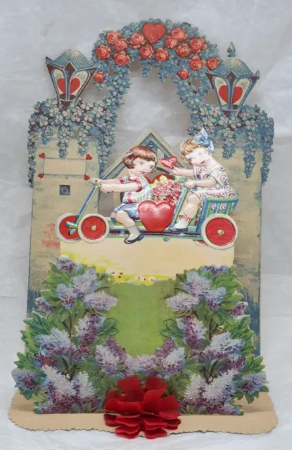 Victorian Embossed Die cut Valentine Pop-up Card Girls ride a bicycle, 8 1/2" h