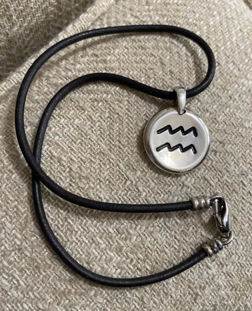 MOVADO Sterling Silver Aquarius Horoscope Pendant Black Cord Necklace MOVADO Sterling Silver Aquarius Horoscope Pendant Black Cord Necklace