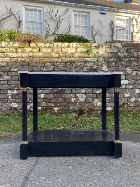 A 19th century ebonised French Empire console table, marble top, 95cm wide