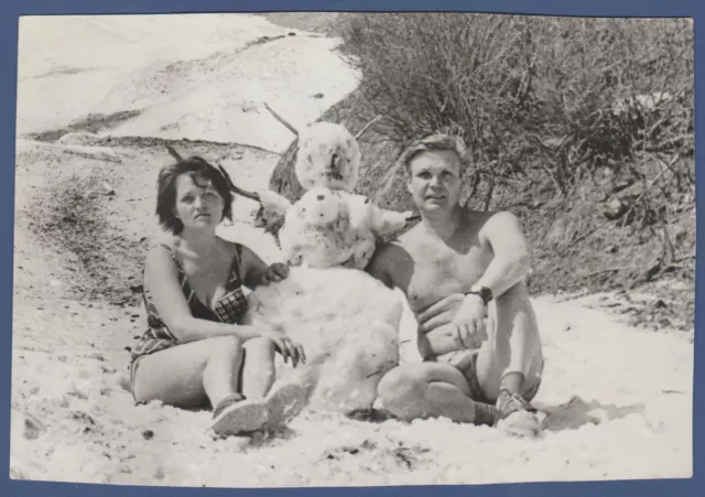 Guy with naked torso, trunks, and girl in swimsuit in snow Soviet Vintage Photo